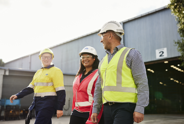 Three BlueScope employees walking left out of facility 