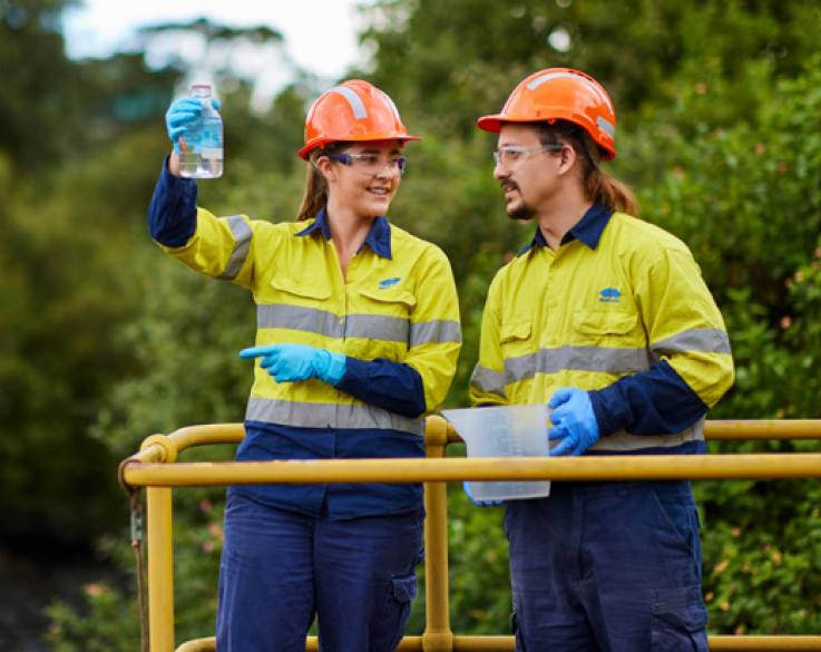 Two BlueScope Employees atop scissor lift in orchard