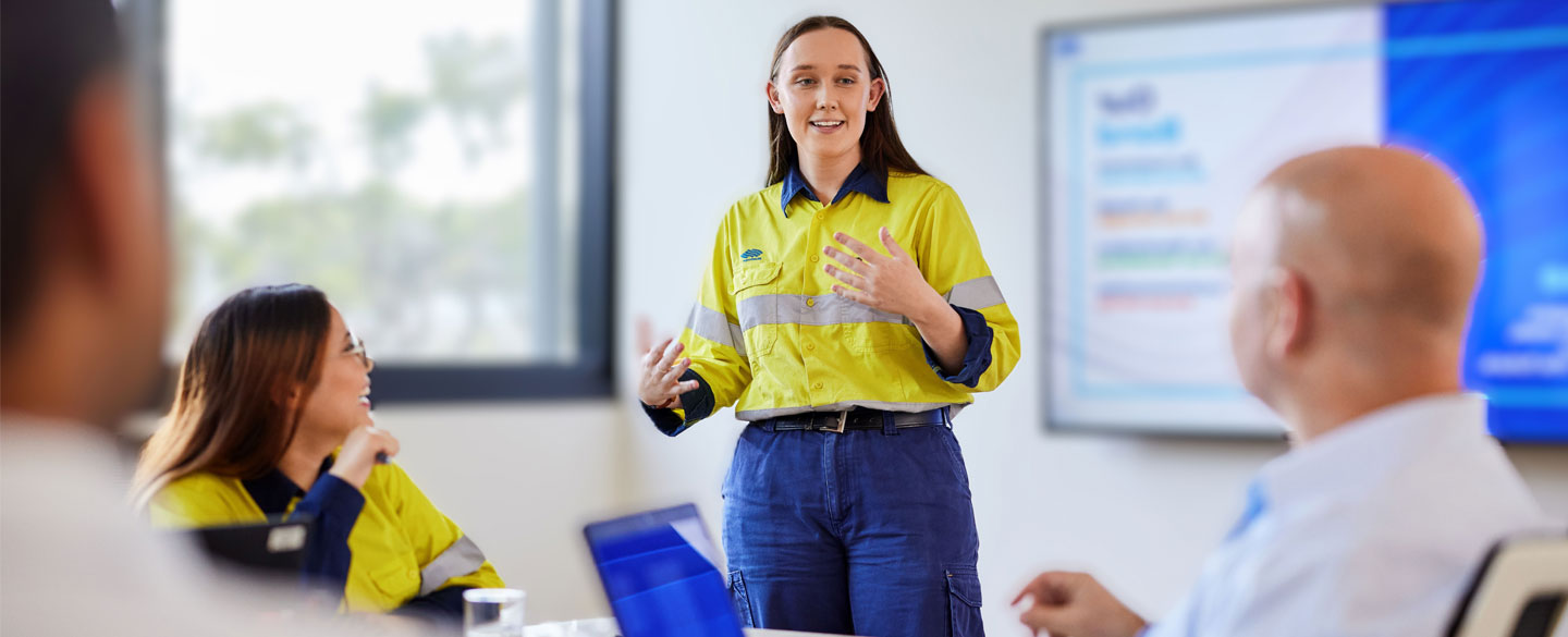 Young BlueScope employee presenting during a board meeting.